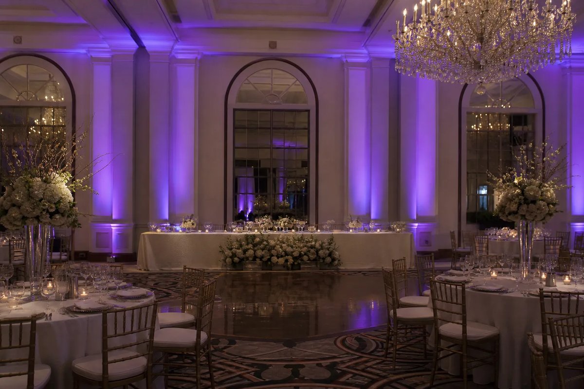 Purple on white columns and arched windows behind the head table
